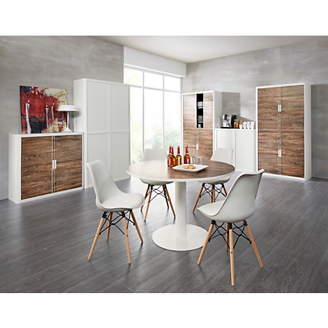 Dining room with wooden table, white chairs, and white cabinets. A painting and a lamp are also in the room.
