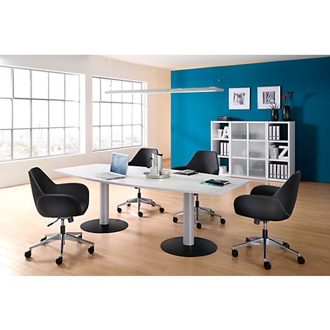 Office with table, chairs and a blue background. A laptop is on the table. Bright windows and ceiling lamp.