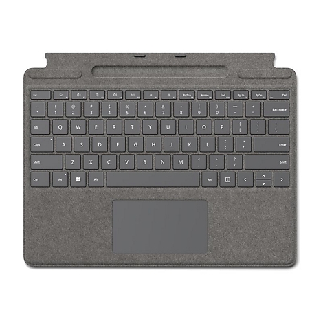 Dunkelgraue Microsoft Surface Tastatur von oben, mit integriertem Touchpad auf strukturiertem Stoffhintergrund.