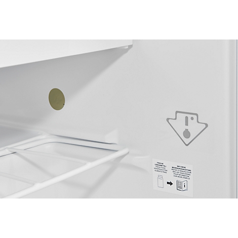 Interior of a white refrigerator, with shelves and stickers.