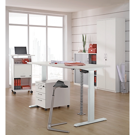 Bright workplace with height-adjustable desk, mobile pedestal, and cabinet. A laptop is ready.