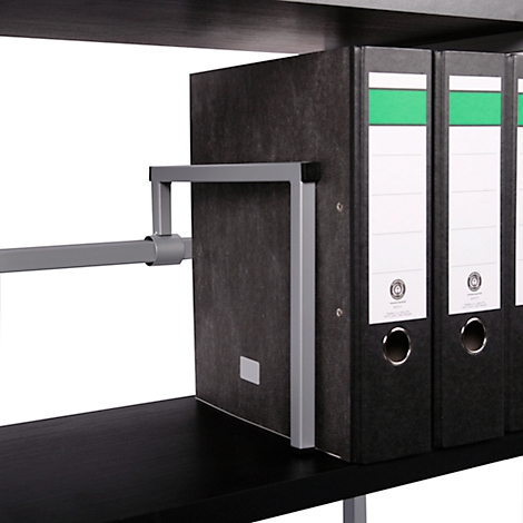Detail shot: Grey metal frame holding folders on a shelf, black binders with white labels and a green stripe.