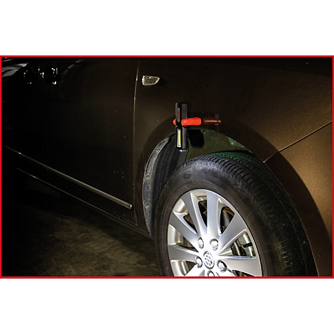 Nahaufnahme eines Reifens und Kotflügels eines Autos. Eine rote und schwarze Lampe wird am Kotflügel befestigt.