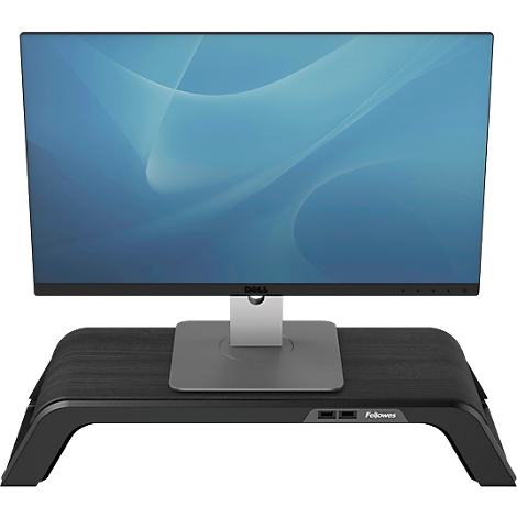 Monitor on a wooden monitor stand, Dell brand. The stand has a black surface and two USB ports.