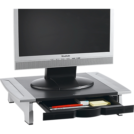 Monitor on a black stand with a drawer. Inside, a red pen, sticky notes, and other small items.