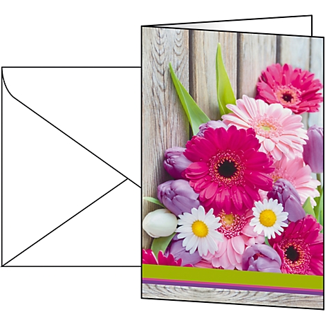 Greeting card with a bouquet of pink gerberas, tulips and daisies. On wood-look background. Envelope next to it.