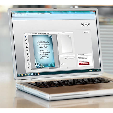 Laptop displaying a Christmas card design website. The text "Merry Christmas and a successful new year!" is visible.