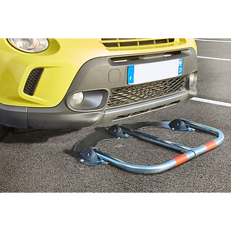 Yellow car with parking barrier in the foreground.