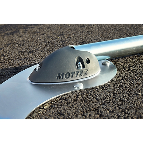 Gray metal construction with the inscription "MOTTEZ" on a black background. A silver pipe is held.