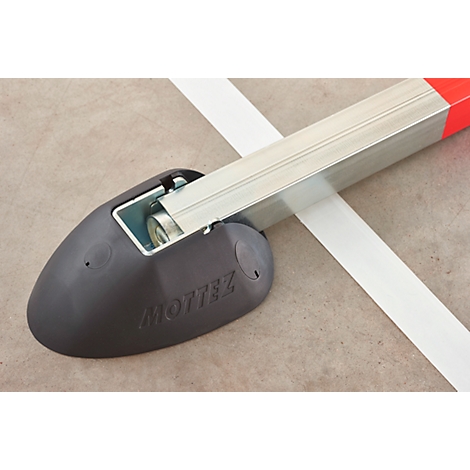 Detailed shot of a gray object holding a white band. The object says "MOTTEZ".