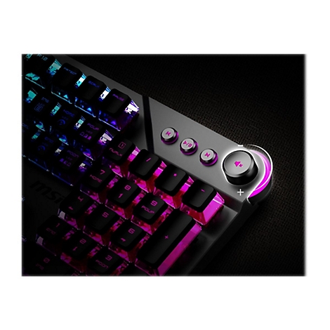 Nahaufnahme einer Gaming-Tastatur mit beleuchteten Tasten in Pink- und BlautÃ¶nen. Auf der Oberseite befinden sich silberfarbene Funktionstasten und ein LautstÃ¤rkeregler.