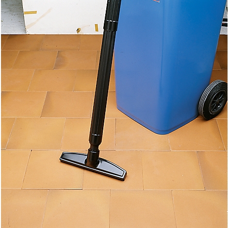 View of a black floor nozzle and blue garbage can with wheel on terracotta tiles.
