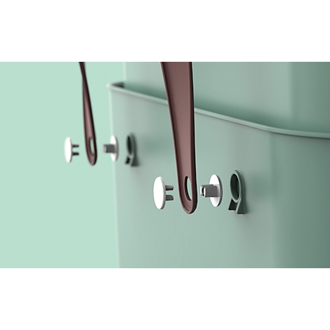 Close-up of detail: handle attachments on a green container, brown handles.