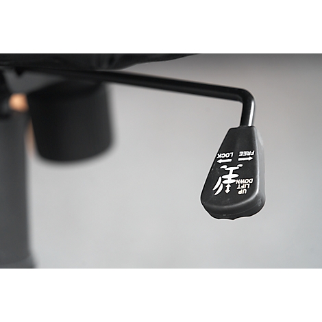 Detail shot of a black lever on an office chair. The lever has white lettering and symbols on it.