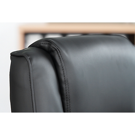 Close-up of the back of a black office chair with decorative stitching.