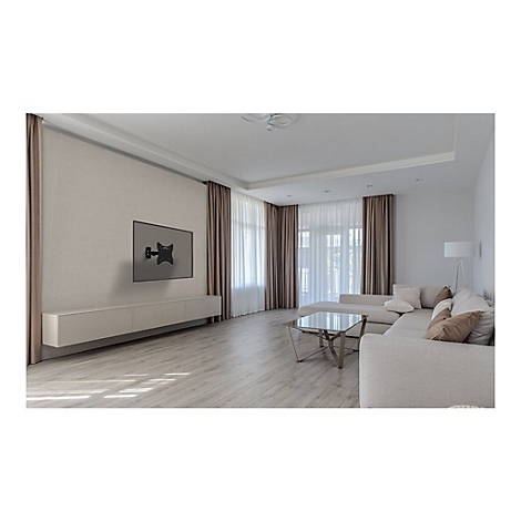 Wohnzimmer mit montiertem TV, helle Wandfarbe, beigefarbene Vorhänge, helles Sofa, Holzboden. 