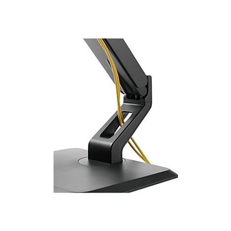 Detailaufnahme einer schwarzen Monitorhalterung mit gelben Kabeln. Der Fuß ist kantig, das Gelenk hat eine Öffnung.