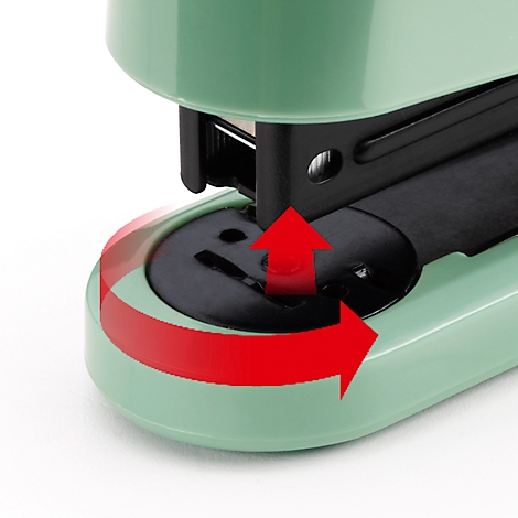 Detail of a green stapler, marked with an arrow for movement.