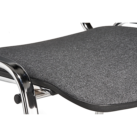 Close-up of a chair seat with grey fabric cover and metal frame.