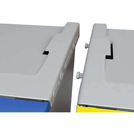 Close-up of two grey plastic boxes. Detailed view of the connection, screws and edges visible.