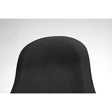 Close-up of the backrest of a black fabric chair against a light background.