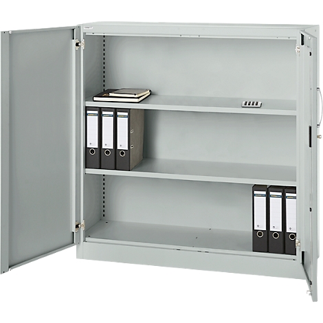 Open, grey steel cabinet with two doors and three shelves. There are folders, a notebook and a small black object on the shelves.