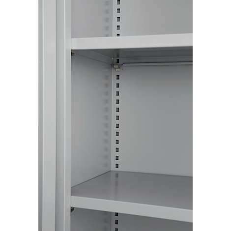 Close-up of the interior of a grey cabinet with shelves and a vertical metal strip with holes.