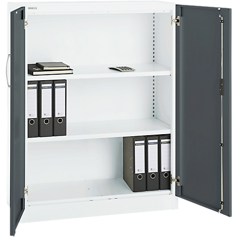 Open white filing cabinet with grey doors filled with binders, notepad and calculator on the shelves.