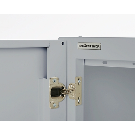 Gray cabinet door with open hinge, a sign with the inscription SCHÄFERSHOP is on the right.