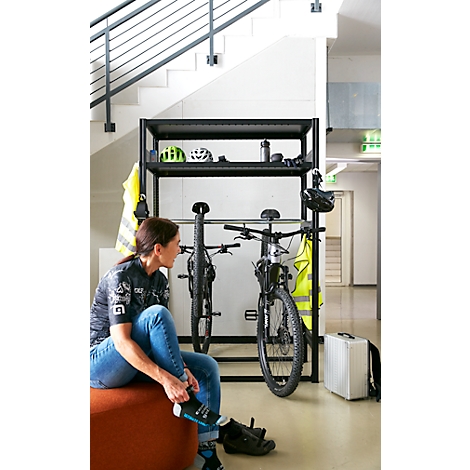 Fietser die schoenen vastmaakt, twee mountainbikes staan 