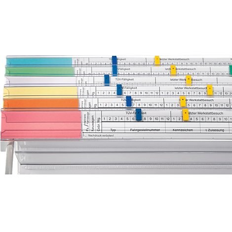 Close-up of colorful index cards, clips marking important data. Text lines with information on vehicle inspection.