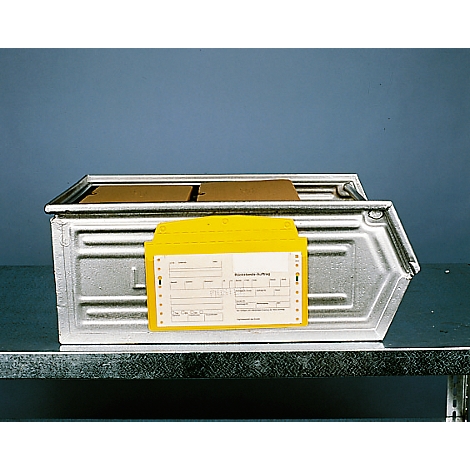 Metal box with yellow documents. Partially legible inscription. Box on table, blue background.