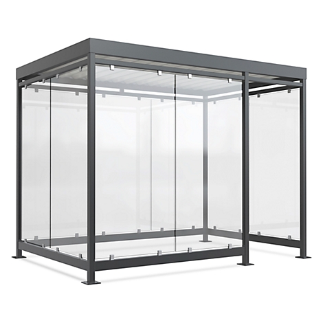 Grey waiting shelter with glass walls and roof. Angular construction. The glasses are set in metal frames.