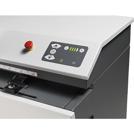 Detailed view of a machine with a red emergency stop button and control panel with green LEDs.