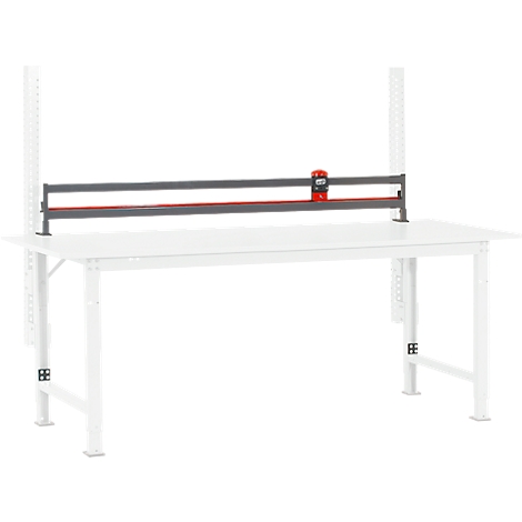 White workbench with a red cutting tool.