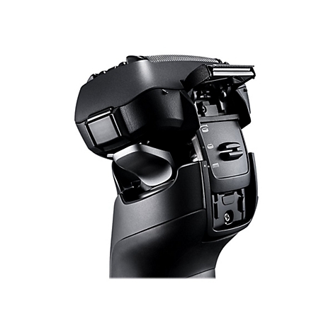 Gros plan d'un rasoir électrique noir avec une tête de rasage ouverte, montrant les lames et les détails du mécanisme.