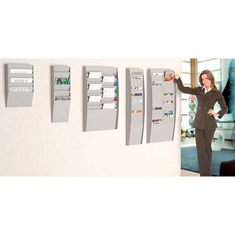 A woman in a suit stands next to wall magazines. Documents are stored in it. Gray color.