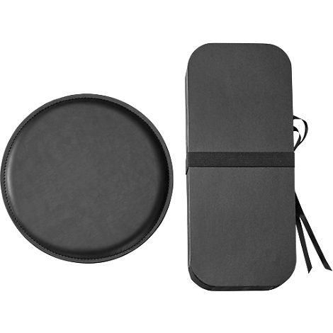 Zwei schwarze Objekte: ein rundes Tablett und eine längliche, rechteckige Box mit Schleife.
