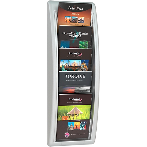 White brochure stand with travel brochures, including "Entre Nous", "Nouvelle-Zélande Voyages", and "Turquie."