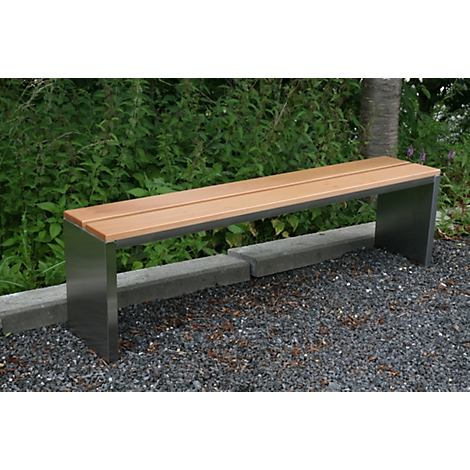 A modern park bench made of wood and metal in the garden. It stands on gravel, with bushes in the background.