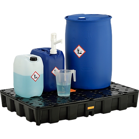 Blue barrels, canisters and beaker with liquid on a black drip pan. Hazard symbols are clearly visible.