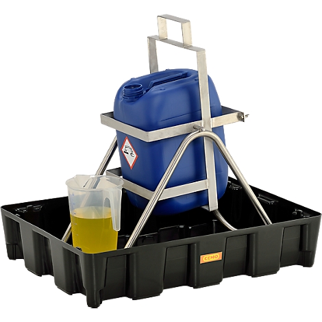 Blue canister in a metal frame, standing in a black spill tray, next to a measuring cup with yellow liquid.