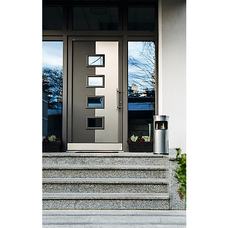 Grey front door with rectangular windows, in front of grey stone steps. Next to it, a silver trash can and flower boxes.