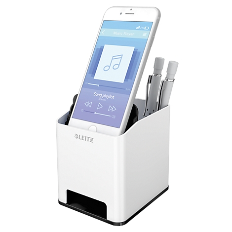 White desk organizer with pens and phone. Phone displays music app.