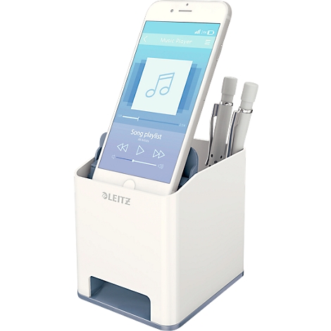 White pen holder with smartphone showing music app. Two white pens stand next to the phone.