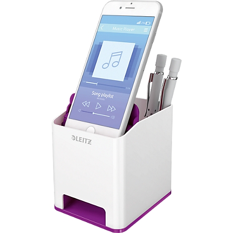White pen holder with smartphone showing a music app. Two pens and a purple accent.