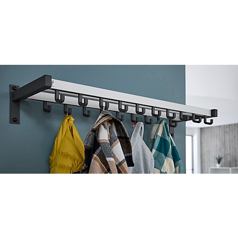 Perchero de pared con ganchos negros, sosteniendo chaquetas coloridas. El fondo es una pared azul-gris.