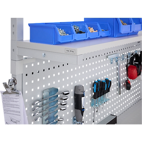Workbench with blue boxes, tools and ear protection.
