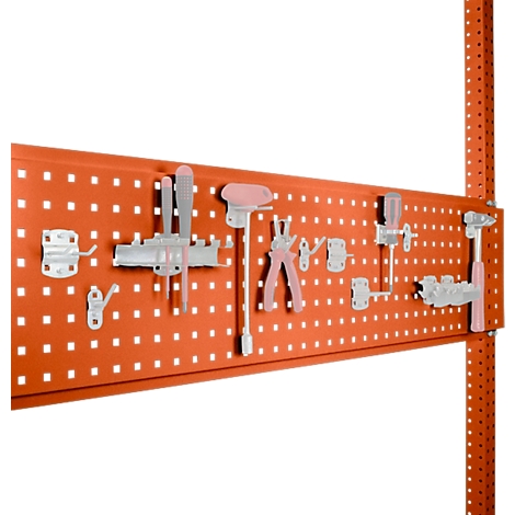 Orange pegboard with tools. Hooks, pliers, screwdrivers, etc. are attached to the pegboard.