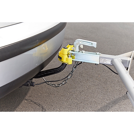 Close-up of a trailer hitch on a grey car. Yellow head, silver bar, chain.